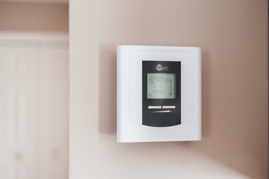 A wall mounted digital heating thermostat